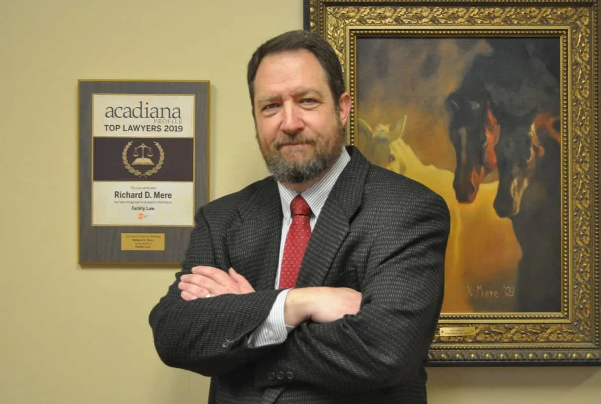 Richard D. Mere with arms crossed beside his Acadiana Profile Top Lawyers 2019 plaque for family law.