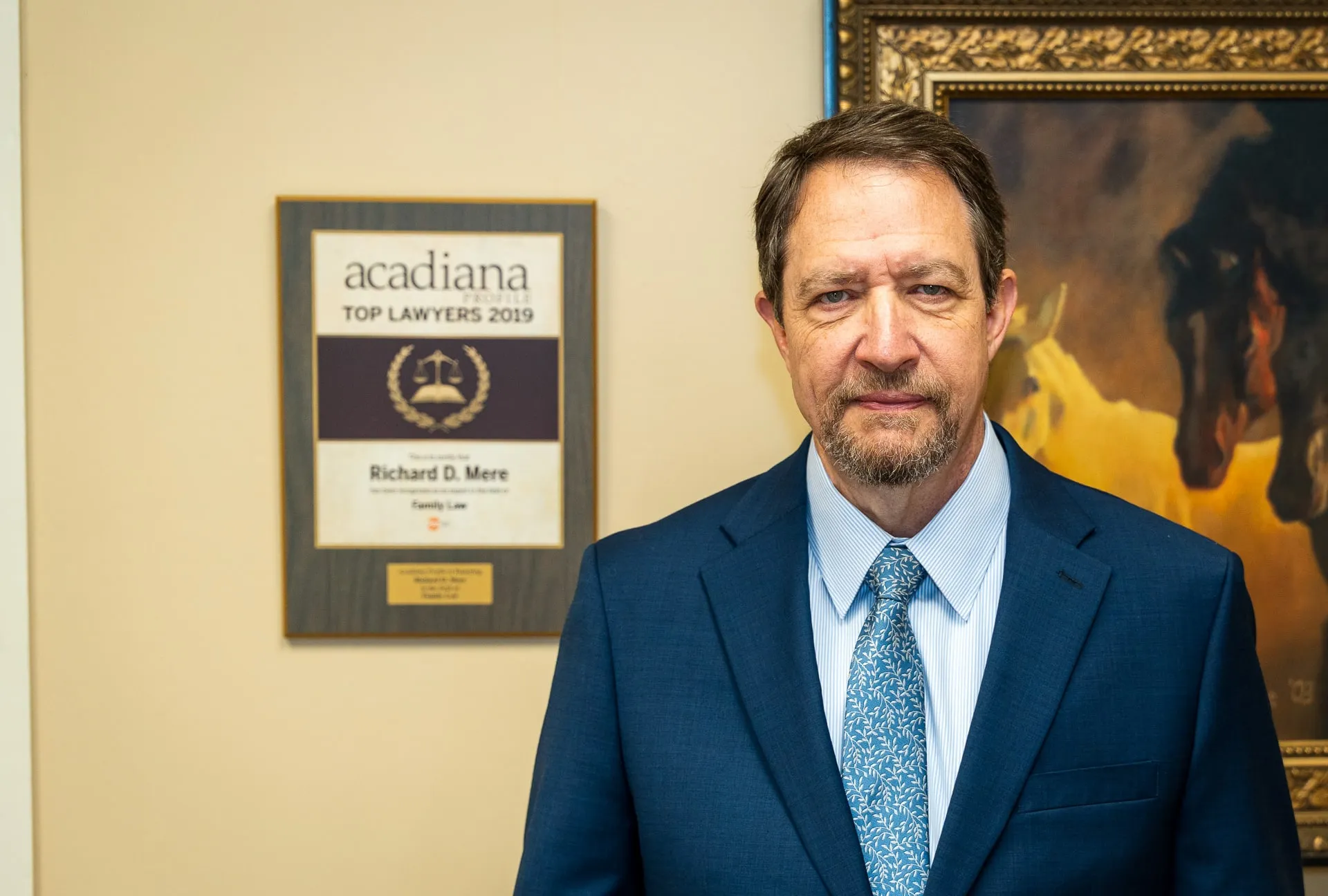 Richard D. Mere beside his Acadiana Profile Top Lawyers 2019 family law plaque at his Lafayette office.